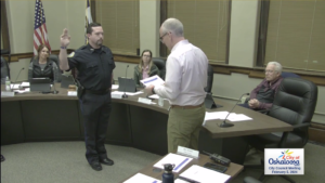 Richard Fortney being sworn in once again as an Oskaloosa Police Officer by Mayor Pro Tem Bob Drost. (image from city council broadcast)